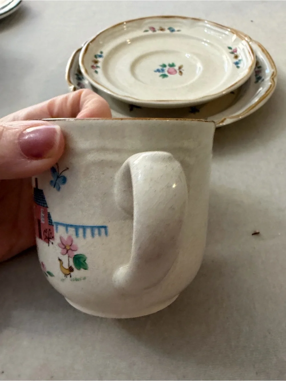 International Cream Ceramic Cup and Saucer Set with Hand-Painted Village Design